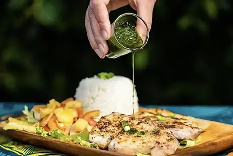 A grilled lagoon fish dish on a restaurant table in Moorea during a private island tour.