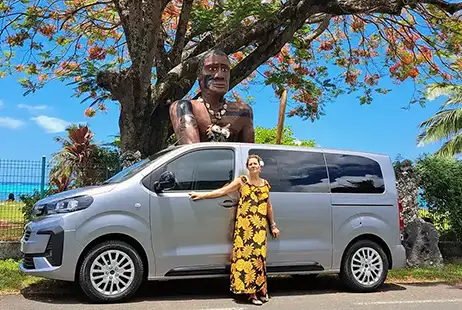 A female guide standing in front of a private guided tour van in Moorea.