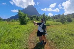 Couple photographing Mount Rotui and the agricultural landscape of Opunohu Valley during a private tour in Moorea
