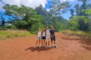 Family posing on Bounty Plateau with Mount Rotui and Moorea mountains behind them