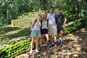 Famille devant un grand marae en pierres volcaniques pendant une visite culturelle guidée à Moorea