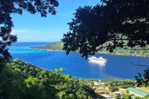Cruise ship in Moorea’s lagoon seen from Magic Mountain above Mareto Beach during a shore excursion