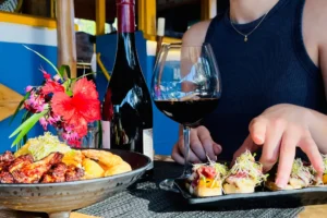 Refined dish with local ingredients and a glass of wine at Uaina O2 Coco restaurant in Moorea