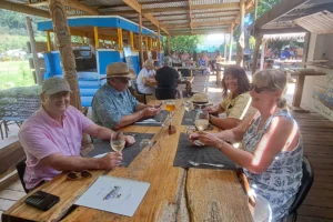 Small group of travelers sharing lunch on the terrace of Truck Uaina O2 Coco in Moorea