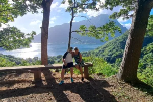 Couple sitting on a bench at the Magic Mountain viewpoint with Mount Rotui and Moorea’s lagoon