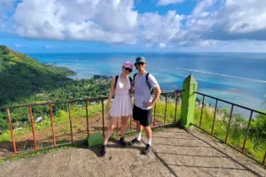 Couple at the top of Magic Mountain in front of the turquoise lagoon during a private Moorea tour