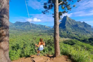 Woman enjoying the panoramic 3 Pinus swing with views over Moorea’s mountains