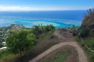 Magic Mountain hiking trail descending toward the turquoise Papeetoai Lagoon in Moorea