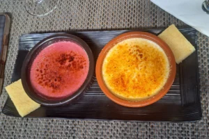 Two tropical-colored crème brûlée desserts served at Uaina O2 Coco restaurant in Moorea