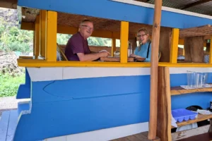 Two guests seated inside Truck Uaina O2 Coco during lunch in Moorea